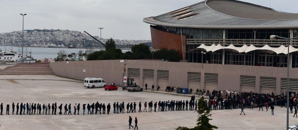 Migrants and refugees line up for food outside of a temporary housing facility for migrants located in a former Olympic hall in Faliro suburb of Athens on December 11, 2015. Migrants and refugees line up for food outside of a temporary housing facility for migrants located in a former Olympic hall in Faliro suburb of Athens on December 11, 2015. - Sputnik International