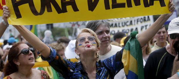 A demonstrator holds a banner which reads Out Dilma during a protest calling for the impeachment of Brazil's President Dilma Rousseff in Rio de Janeiro - Sputnik International