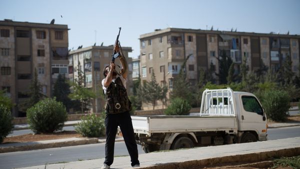 A Syrian rebel fighter fires his AK-47 rifle towards a Syrian army helicopter in Aleppo's Hanano district - Sputnik International