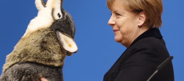 German Chancellor Angela Merkel holds a toy wolf she got as a present during a party convention of the Christian Democrats (CDU) in Karlsruhe, Germany, Monday, Dec. 14, 2015. German Chancellor Angela Merkel holds a toy wolf she got as a present during a party convention of the Christian Democrats (CDU) in Karlsruhe, Germany, Monday, Dec. 14, 2015. - Sputnik International
