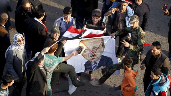 Protesters use slippers to hit a banner with a caricature of Turkish President Tayyip Erdogan during a demonstration against the Turkish military deployment in Iraq, at Tahrir Square in central Baghdad, Iraq, December 12, 2015 Protesters use slippers to hit a banner with a caricature of Turkish President Tayyip Erdogan during a demonstration against the Turkish military deployment in Iraq, at Tahrir Square in central Baghdad, Iraq, December 12, 2015 - Sputnik International