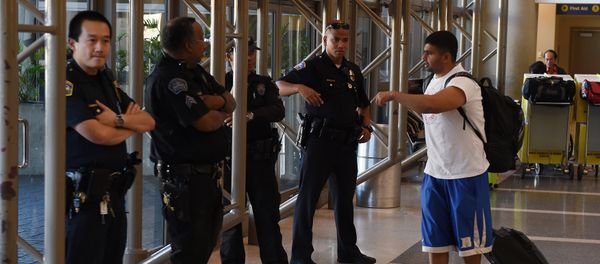 Police keep watch over passengers at Los Angeles International Airport after the US State Department issued a worldwide travel alert warning US citizens of the heightened risks of traveling due to increased terrorist threats November 23, 2015 in Los Angeles, California - Sputnik International