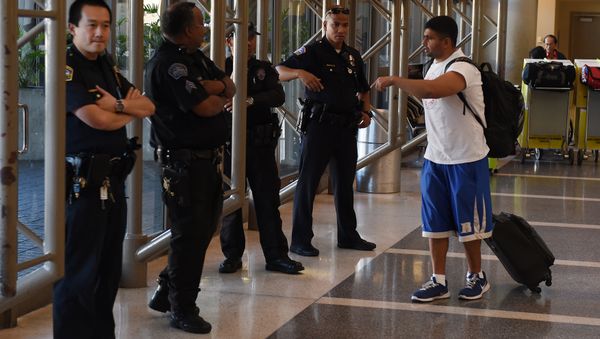 Police keep watch over passengers at Los Angeles International Airport after the US State Department issued a worldwide travel alert warning US citizens of the heightened risks of traveling due to increased terrorist threats November 23, 2015 in Los Angeles, California Police keep watch over passengers at Los Angeles International Airport after the US State Department issued a worldwide travel alert warning US citizens of the heightened risks of traveling due to increased terrorist threats November 23, 2015 in Los Angeles, California - Sputnik International