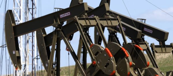 This June 12, 2014 file photo shows four pumps at an oil production facility in Watford City, N.D. - Sputnik International