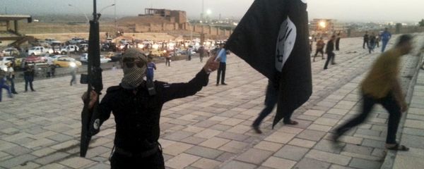 A fighter of the Islamic State of Iraq and the Levant (ISIL) holds an ISIL flag and a weapon on a street in the city of Mosul, Iraq, in this June 23, 2014 file photo A fighter of the Islamic State of Iraq and the Levant (ISIL) holds an ISIL flag and a weapon on a street in the city of Mosul, Iraq, in this June 23, 2014 file photo - Sputnik International