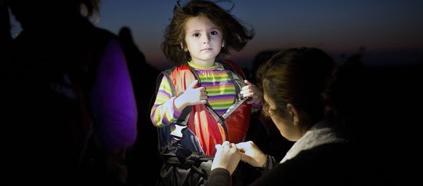 A child gets assistance to remove her life jacket upon her arrival on an inflatable boat carrying migrants on the Greek island of Kos after crossing a part of the Aegean Sea between Turkey and Greece on August 13, 2015. A child gets assistance to remove her life jacket upon her arrival on an inflatable boat carrying migrants on the Greek island of Kos after crossing a part of the Aegean Sea between Turkey and Greece on August 13, 2015. - Sputnik International