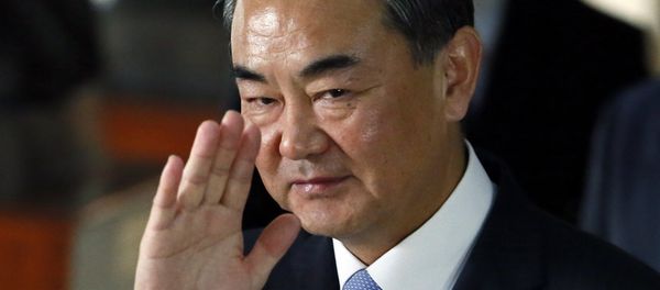Chinese Foreign Minster Wang Yi waves to the media as he leaves the Department of Foreign Affairs following his talks with Philippine Foreign Secretary Albert Del Rosario Tuesday, Nov. 10, 2015 at suburban Pasay city, south of Manila, Philippines - Sputnik International