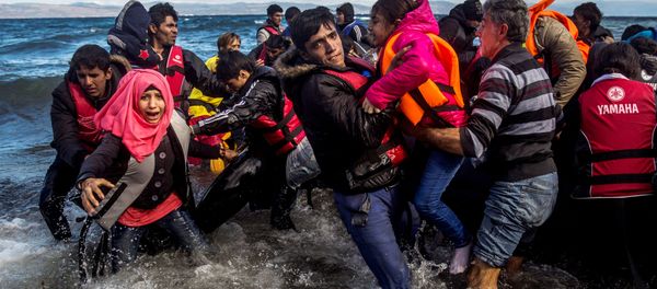 Migrants disembark safely from their frail boat in bad weather on the Greek island of Lesbos after crossing the Aegean see from Turkey, Wednesday, Oct. 28, 2015. - Sputnik International