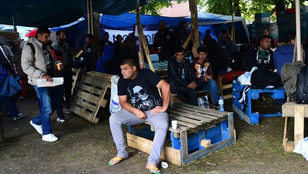 Migrants wait in a makeshift tent camp in a park in Brussels on September 9, 2015, as they wait to have their asylum claims processed Migrants wait in a makeshift tent camp in a park in Brussels on September 9, 2015, as they wait to have their asylum claims processed - Sputnik International