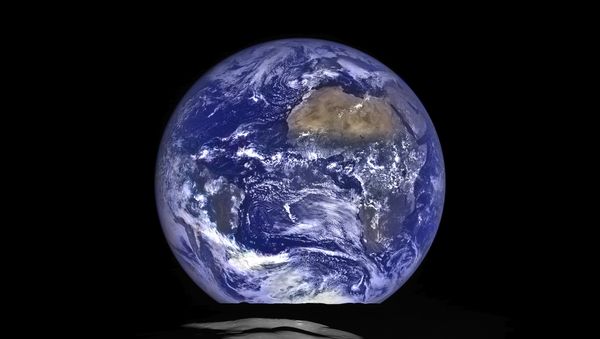 The Earth straddling the limb of the Moon, as seen from above Compton crater. Center of the Earth in this view is 4.04°N, 12.44°W, just off the coast of Liberia. The large tan area in the upper right is the Sahara desert, and just beyond is Saudia Arabia. The Atlantic and Pacific coasts of South America are visible to the left. WAC E1199291151C (Earth only), NAC M1199291564LR (Earth and Moon); sequence start time 12 October 2015 12:18:17.384 UTC - Sputnik International