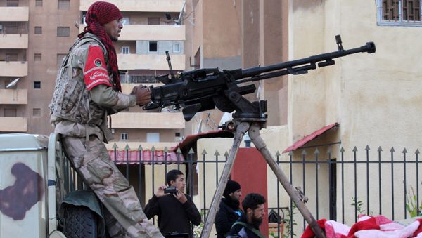 A member of the pro-government Libyan forces stands on top of an armed vehicle during a attack on districts held by Islamist militias A member of the pro-government Libyan forces stands on top of an armed vehicle during a attack on districts held by Islamist militias - Sputnik International