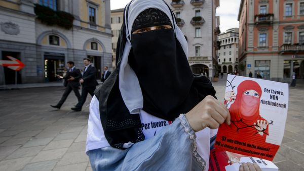 Islamic Central Council of Switzerland (ICCS - CCIS) member Nora Illi, one of the few Swiss women wearing the niqab, poses on September 18, 2013 while distributing flyers reading Please don't lock me up in Lugano against an upcoming cantonal vote on banning face-covering headgear in public places (File) - Sputnik International