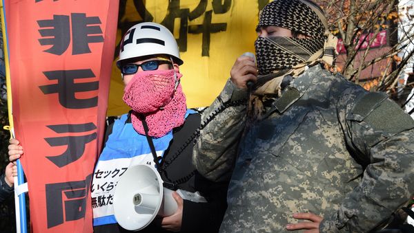 Leaders of a group of men calling themselves losers with women, shout anti-Christmas slogans during a rally before a demonstration at Shibuya shopping district in Tokyo on December 19, 2015. Angry Japanese men hit the streets of downtown Tokyo calling the sham Christmas festive mood for happy couples be smashed. - Sputnik International