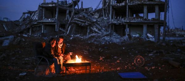 Kurdish men sit near bonfire near a destroyed building, in the Syrian Kurdish town of Kobane, also known as Ain al-Arab Kurdish men sit near bonfire near a destroyed building, in the Syrian Kurdish town of Kobane, also known as Ain al-Arab - Sputnik International