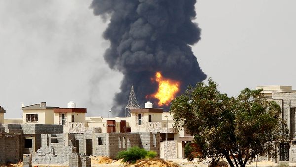 A picture taken on July 28, 2014 shows flames and smoke billowing from an oil depot where a huge blaze started following clashes around Tripoli airport, in southern Tripoli - Sputnik International