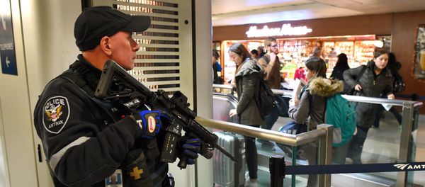File Photo: An Amtrak Police officer watches passengersas they board a train at Penn Station on November 24, 2015 in New York. After a string of terror attacks in several countries, the US government issued a worldwide travel alert warning American citizens of increased terrorist threats File Photo: An Amtrak Police officer watches passengersas they board a train at Penn Station on November 24, 2015 in New York. After a string of terror attacks in several countries, the US government issued a worldwide travel alert warning American citizens of increased terrorist threats - Sputnik International
