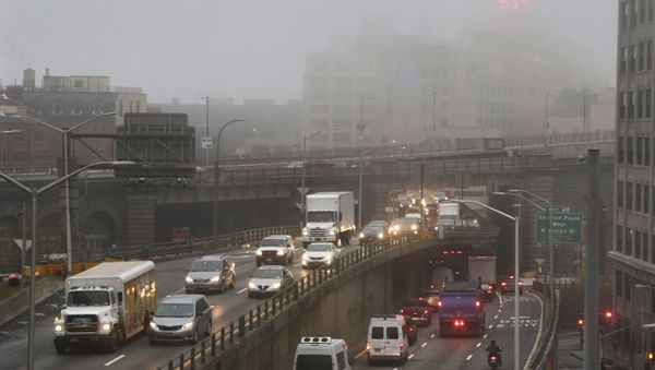 Traffic passes along a foggy Brooklyn Queens Expressway, Wednesday, Dec. 23, 2015 in New York. A weather pattern partly linked with El Nino has turned winter upside-down across the U.S. during a week of heavy holiday travel, bringing spring-like warmth to the Northeast, a risk of tornadoes in the South and so much snow across the West that even skiing slopes have been overwhelmed Traffic passes along a foggy Brooklyn Queens Expressway, Wednesday, Dec. 23, 2015 in New York. A weather pattern partly linked with El Nino has turned winter upside-down across the U.S. during a week of heavy holiday travel, bringing spring-like warmth to the Northeast, a risk of tornadoes in the South and so much snow across the West that even skiing slopes have been overwhelmed - Sputnik International