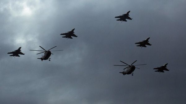 In this Aug. 23, 2015 file photo, Chinese Mi-8 military helicopters and J-16 fighter jets fly over central Beijing during a rehearsal for a large military parade. - Sputnik International