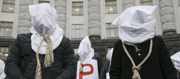 Activists with bags on their heads and ropes around their necks demand an increase in state funding for the treatment of seriously ill people in front of the government building in Kiev, Ukraine, December 23, 2015 Activists with bags on their heads and ropes around their necks demand an increase in state funding for the treatment of seriously ill people in front of the government building in Kiev, Ukraine, December 23, 2015 - Sputnik International