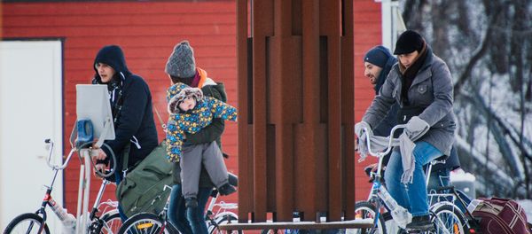 Refugees walk alongside there bikes to the Norwegian border crossing station at Storskog after crossing the border from Russia on November 12, 2015 near Kirkenes Refugees walk alongside there bikes to the Norwegian border crossing station at Storskog after crossing the border from Russia on November 12, 2015 near Kirkenes - Sputnik International