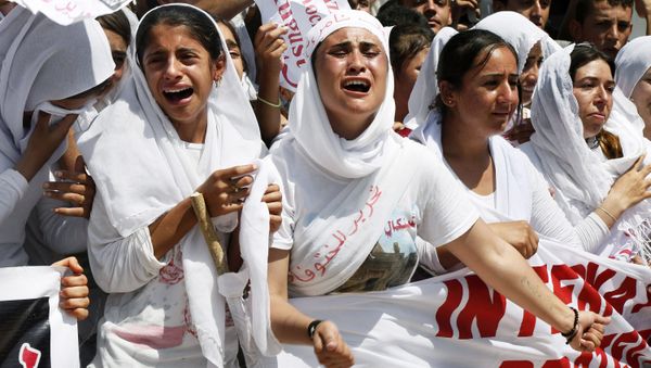 Yazidi Kurdish women chant slogans during a protest against the Islamic State group's invasion on Sinjar city one year ago, in Dohuk, northern Iraq, Monday, Aug. 3, 2015 - Sputnik International