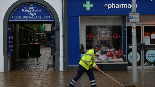 A worker clears silt and debris from a road in Cockermouth, northern England, on December 7, 2015 as the clean up starts following heavy flooding in the town caused by Storm Desmond A worker clears silt and debris from a road in Cockermouth, northern England, on December 7, 2015 as the clean up starts following heavy flooding in the town caused by Storm Desmond - Sputnik International