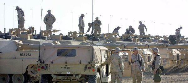 US troops are seen on top of their tanks, as others chat next to an armored vehicle (File) US troops are seen on top of their tanks, as others chat next to an armored vehicle (File) - Sputnik International
