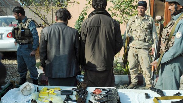 Afghan security forces stand guard around two arrested so-called IS fighters in Jalalabad, capital of Nangarhar province, Afghanistan, Wednesday, Dec. 23, 2015 Afghan security forces stand guard around two arrested so-called IS fighters in Jalalabad, capital of Nangarhar province, Afghanistan, Wednesday, Dec. 23, 2015 - Sputnik International