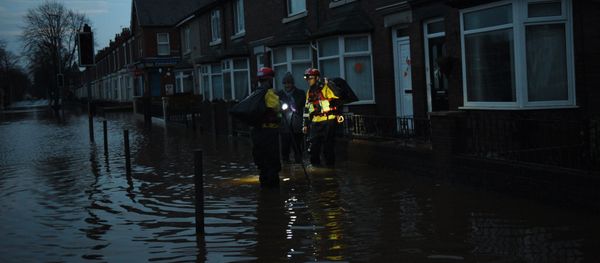 Members of the RSPCA help a woman retrieve possessions from her flooded property in Carlisle, north west England on December 7, 2015 Members of the RSPCA help a woman retrieve possessions from her flooded property in Carlisle, north west England on December 7, 2015 - Sputnik International