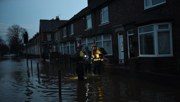 Members of the RSPCA help a woman retrieve possessions from her flooded property in Carlisle, north west England on December 7, 2015 Members of the RSPCA help a woman retrieve possessions from her flooded property in Carlisle, north west England on December 7, 2015 - Sputnik International