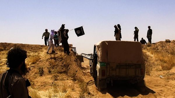An image made available by the jihadist Twitter account Al-Baraka news on June 9, 2014 allegedly shows Islamic State of Iraq and the Levant (ISIL) militants waving the trademark Jihadits flag as vehicles drive on a newly cut road through the Syrian-Iraqi border between the Iraqi Nineveh province and the Syrian town of Al-Hasakah An image made available by the jihadist Twitter account Al-Baraka news on June 9, 2014 allegedly shows Islamic State of Iraq and the Levant (ISIL) militants waving the trademark Jihadits flag as vehicles drive on a newly cut road through the Syrian-Iraqi border between the Iraqi Nineveh province and the Syrian town of Al-Hasakah - Sputnik International