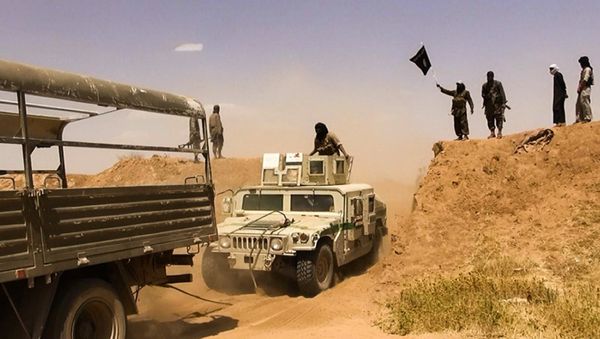 Islamic State of Iraq and the Levant (ISIL) militants waving the trademark Jihadits flag as vehicles drive on a newly cut road through the Syrian-Iraqi border between the Iraqi Nineveh province and the Syrian town of Al-Hasakah (File) - Sputnik International