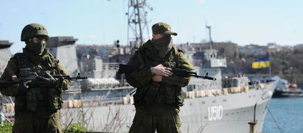 Russian forces look out at the Ukrainian navy ship Slavutich in the harbor of the Ukrainian city of Sevastopol on March 5, 2014 - Sputnik International