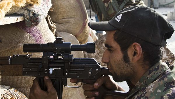 FILE - In this Wednesday, Nov. 19, 2014 file photo, Kurdish People's Protection Units (YPG) fighters take position at a stronghold in Kobani, Syria. Drawing on thousands of fighters from Syria's mix of religious and ethnic groups, a U.S.-backed alliance called the Syrian Democratic Forces has emerged as the most effective fighting force against the Islamic State group in Syria. - Sputnik International