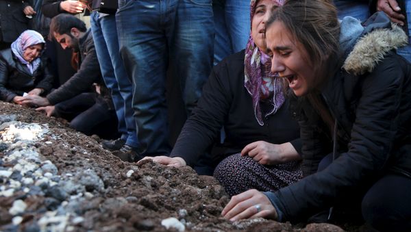 Relatives of Siyar Salman mourn over his grave during a funeral ceremony in the Kurdish dominated southeastern city of Diyarbakir, Turkey, December 15, 2015. According to local media, Salman, a 19-year old man, was killed on Monday in Diyarbakir during a protest against the curfew in Sur district. Relatives of Siyar Salman mourn over his grave during a funeral ceremony in the Kurdish dominated southeastern city of Diyarbakir, Turkey, December 15, 2015. According to local media, Salman, a 19-year old man, was killed on Monday in Diyarbakir during a protest against the curfew in Sur district. - Sputnik International