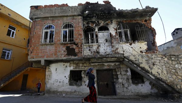 A woman walks past a building which was damaged during the security operations and clashes between Turkish security forces and Kurdish militants, in the southeastern town of Silvan in Diyarbakir province, Turkey, December 7, 2015. A woman walks past a building which was damaged during the security operations and clashes between Turkish security forces and Kurdish militants, in the southeastern town of Silvan in Diyarbakir province, Turkey, December 7, 2015. - Sputnik International