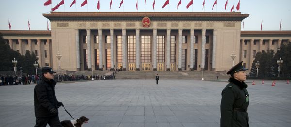 A Chinese paramilitary policeman, right, stands guard in front of the Great Hall of the People as a security officer walks past with a search dog before the opening session of the annual National People's Congress in Beijing, Thursday, March 5, 2015 A Chinese paramilitary policeman, right, stands guard in front of the Great Hall of the People as a security officer walks past with a search dog before the opening session of the annual National People's Congress in Beijing, Thursday, March 5, 2015 - Sputnik International