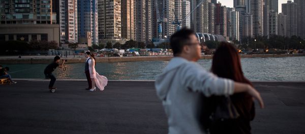 A couple (L) pose for their pre-wedding photographs on a public pier in Hong Kong on November 28, 2015 A couple (L) pose for their pre-wedding photographs on a public pier in Hong Kong on November 28, 2015 - Sputnik International