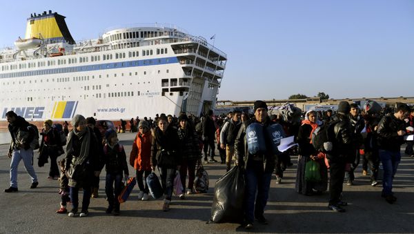 Refugees and migrants walk after disembarking from the passenger ferry Eleftherios Venizelos from the island of Lesbos at the port of Piraeus, near Athens, Greece, December 26, 2015 Refugees and migrants walk after disembarking from the passenger ferry Eleftherios Venizelos from the island of Lesbos at the port of Piraeus, near Athens, Greece, December 26, 2015 - Sputnik International