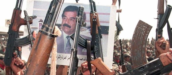 Iraqi soldiers hold up their arms during celebrations to mark the 61st birthday of Iraqi President Saddam Hussein 28 April 1998, in his home town of Tikrit, north of Baghdad - Sputnik International