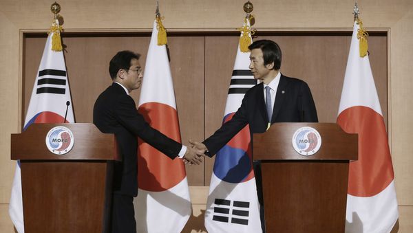 South Korean Foreign Minister Yun Byung-se, right, shakes hands with his Japanese counterpart Fumio Kishida after their joint press conference at Foreign Ministry in Seoul, South Korea, Monday, Dec. 28, 2015. The foreign ministers said they had reached a deal meant to resolve a decades-long impasse over Korean women forced into Japanese military-run brothels during World War II, a potentially dramatic breakthrough between the Northeast Asian neighbors and rivals South Korean Foreign Minister Yun Byung-se, right, shakes hands with his Japanese counterpart Fumio Kishida after their joint press conference at Foreign Ministry in Seoul, South Korea, Monday, Dec. 28, 2015. The foreign ministers said they had reached a deal meant to resolve a decades-long impasse over Korean women forced into Japanese military-run brothels during World War II, a potentially dramatic breakthrough between the Northeast Asian neighbors and rivals - Sputnik International