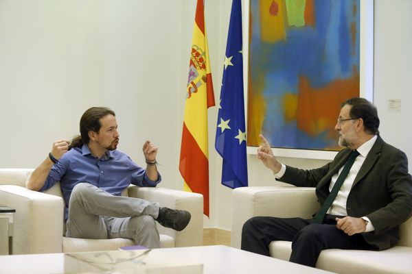 Spain's Prime Minister Mariano Rajoy, right, talks to Podemos party leader Pablo Iglesias during their meeting at the Moncloa palace, the Spanish premier's official residence, in Madrid. - Sputnik International