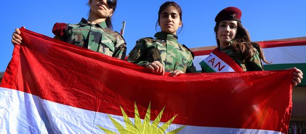 Iraqi Kurdish girls carry a Kurdistan flag during the celebration of Flag Day in the northern city of Arbil, the capital of the autonomous Kurdish region in northern Iraq Iraqi Kurdish girls carry a Kurdistan flag during the celebration of Flag Day in the northern city of Arbil, the capital of the autonomous Kurdish region in northern Iraq - Sputnik International