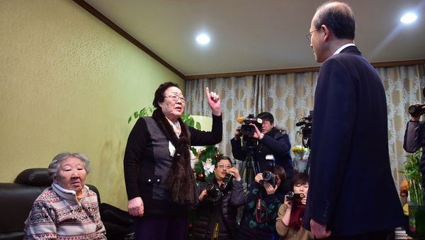 Former Korean sex slave Lee Yong-su, second from left, makes a gesture of protest at South Korean First Vice Foreign Minister Lim Sung-nam, right, during his visit to a shelter for women, who were forcibly recruited to work in Japanese wartime military brothels, in Seoul - Sputnik International