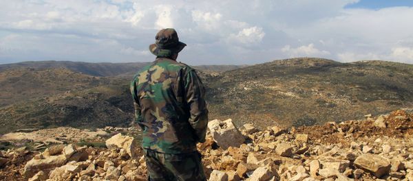 Hezbollah fighter looks toward Syria while standing in the fields of the Lebanese border village of Brital, Lebanon. (File) Hezbollah fighter looks toward Syria while standing in the fields of the Lebanese border village of Brital, Lebanon. (File) - Sputnik International
