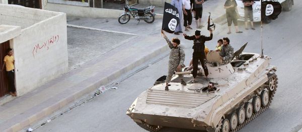 Militant Islamist fighters take part in a military parade along the streets of northern Raqqa province in this June 30, 2014, file photo - Sputnik International
