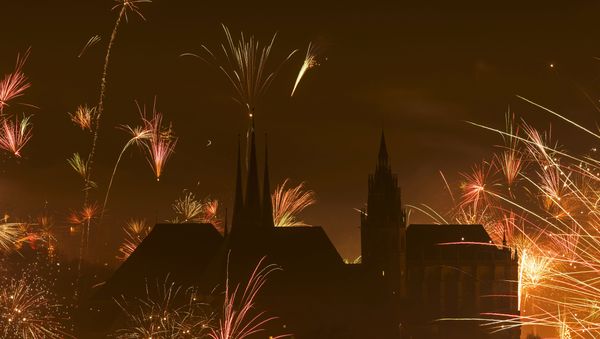 In this photo taken with long exposure, fireworks explode near the medieval Mariendom or St. Mary's Cathedral, right, and St. Severi's Church shortly after midnight during the New Year celebrations in Erfurt, central Germany, Friday, Jan. 1, 2016 - Sputnik International