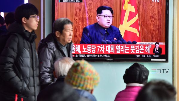 Commuters walk past a television screen showing a broadcast of North Korean leader Kim Jong-Un's New Year speech, at a railroad station in Seoul on January 1, 2016 Commuters walk past a television screen showing a broadcast of North Korean leader Kim Jong-Un's New Year speech, at a railroad station in Seoul on January 1, 2016 - Sputnik International
