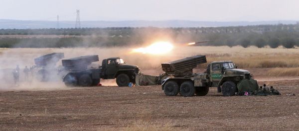 In this photo taken on Wednesday, Oct. 7, 2015, Syrian army rocket launchers fire near the village of Morek in Syria In this photo taken on Wednesday, Oct. 7, 2015, Syrian army rocket launchers fire near the village of Morek in Syria - Sputnik International