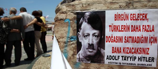 A depiction of Turkish Prime Minister Recep Tayyip Erdogan portraying him as Nazi leader Adolf Hitler is pasted on the front of Mustafa Kemal Ataturk's statue, founder of Turkey, at the Taksim square in Istanbul on Thursday, June 6, 2013 A depiction of Turkish Prime Minister Recep Tayyip Erdogan portraying him as Nazi leader Adolf Hitler is pasted on the front of Mustafa Kemal Ataturk's statue, founder of Turkey, at the Taksim square in Istanbul on Thursday, June 6, 2013 - Sputnik International